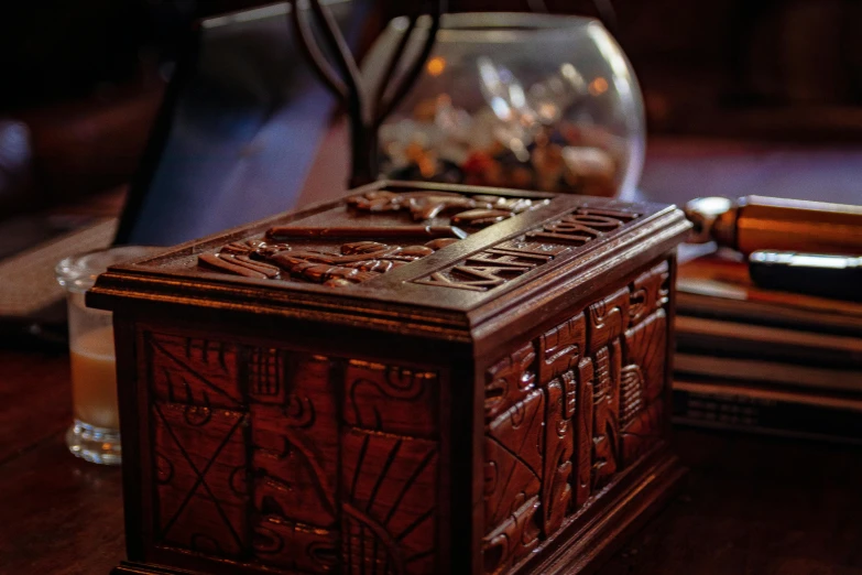 an ornate wooden box sitting on top of a table
