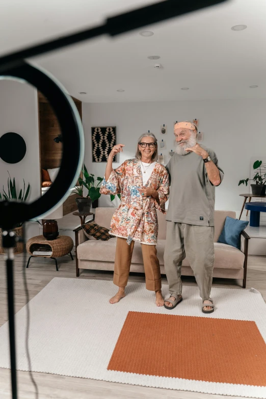 the couple takes a picture in their studio