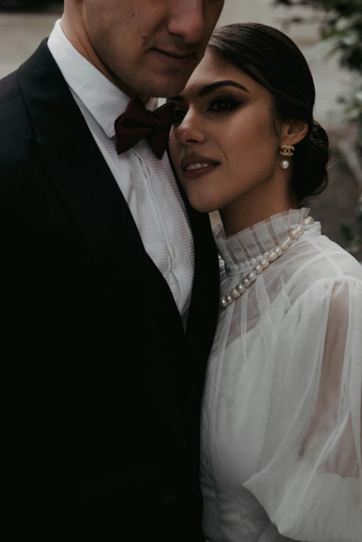 a young couple standing close together on a sidewalk