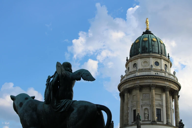 a statue of an angel next to a building