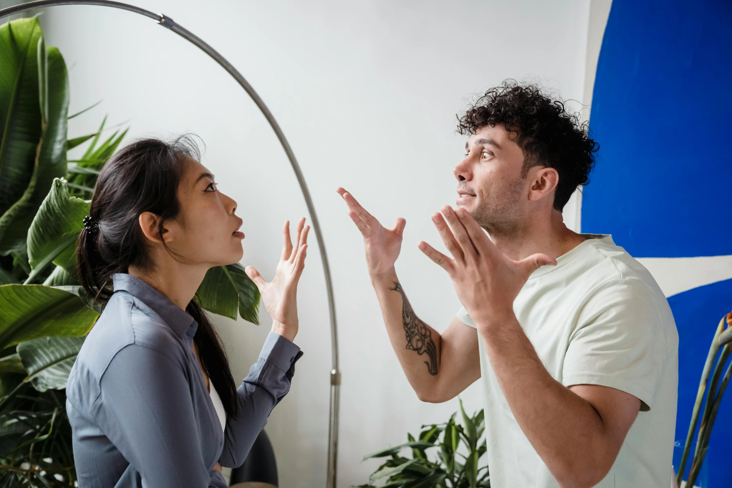 two people talking with hands in front of them