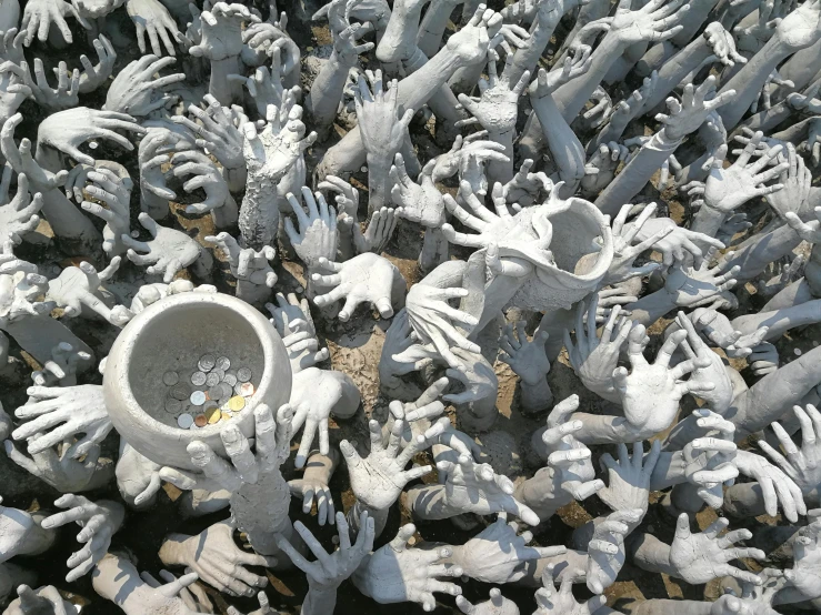 a bowl with many hands in it is surrounded by small handprints