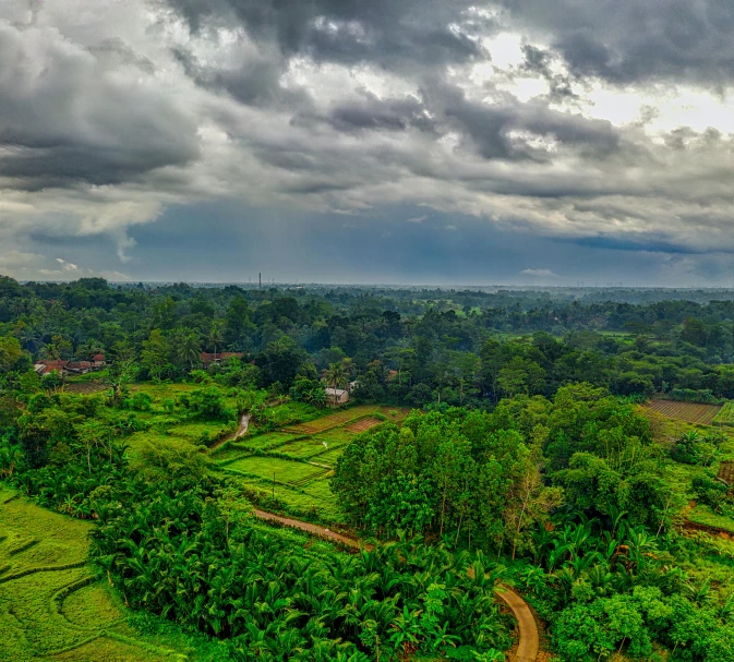 clouds roll in over a lush green countryside