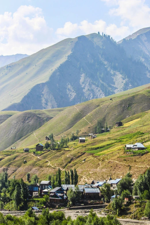 some buildings and mountains with the sky in the background