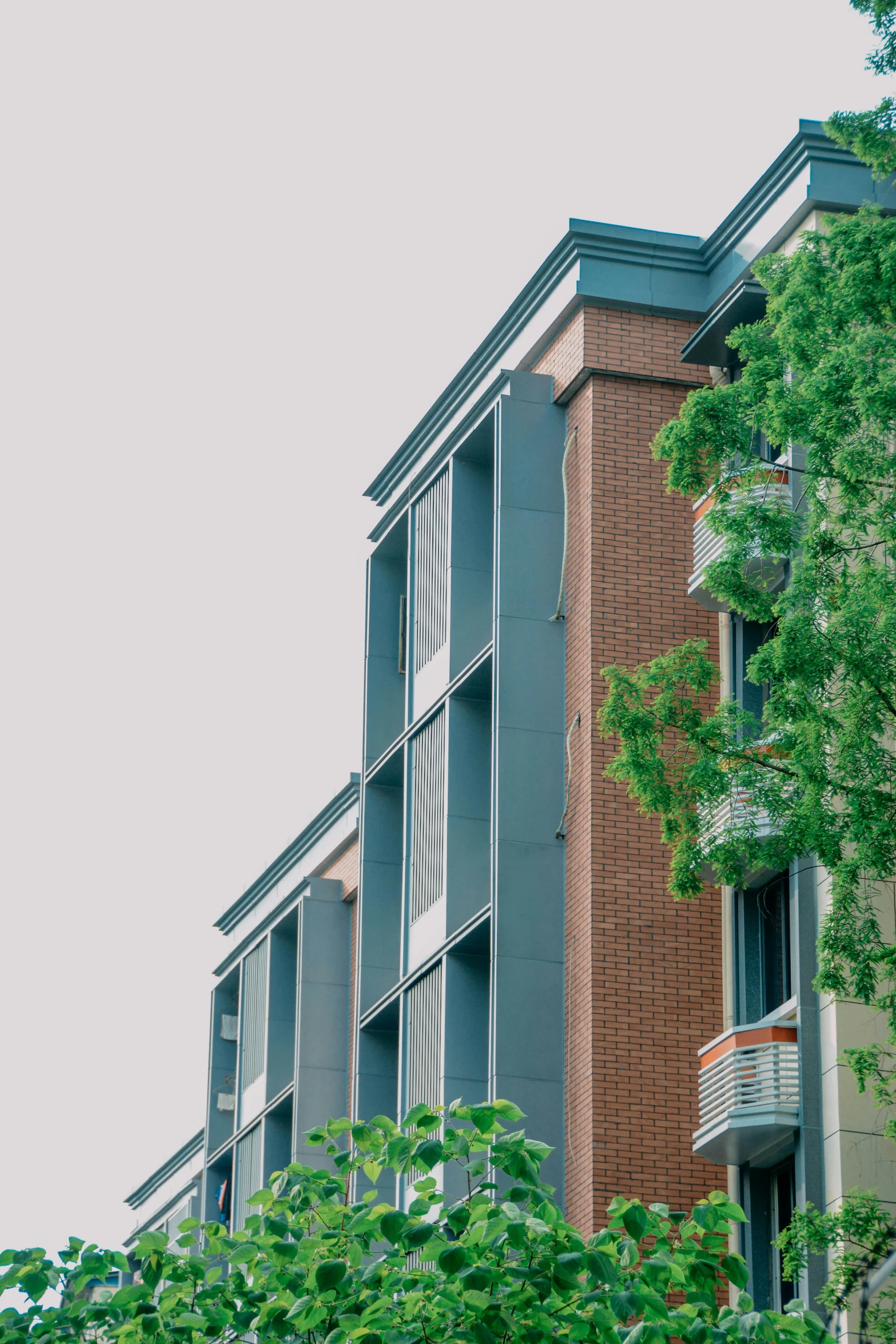 a tall brick building with windows and balconies on the side