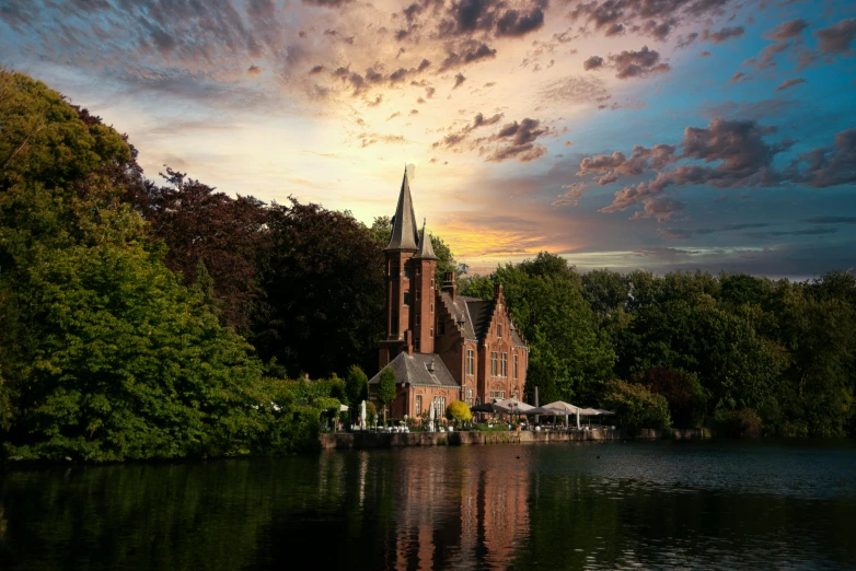 a church on an island near the water at sunset