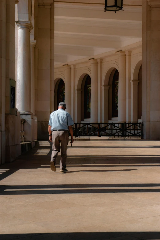 a man riding a skateboard down an empty walkway