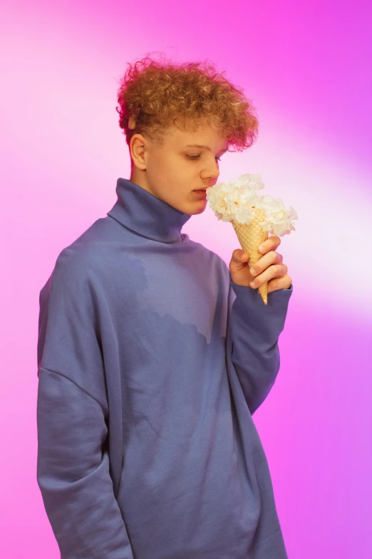 young man posing holding an ice cream cone