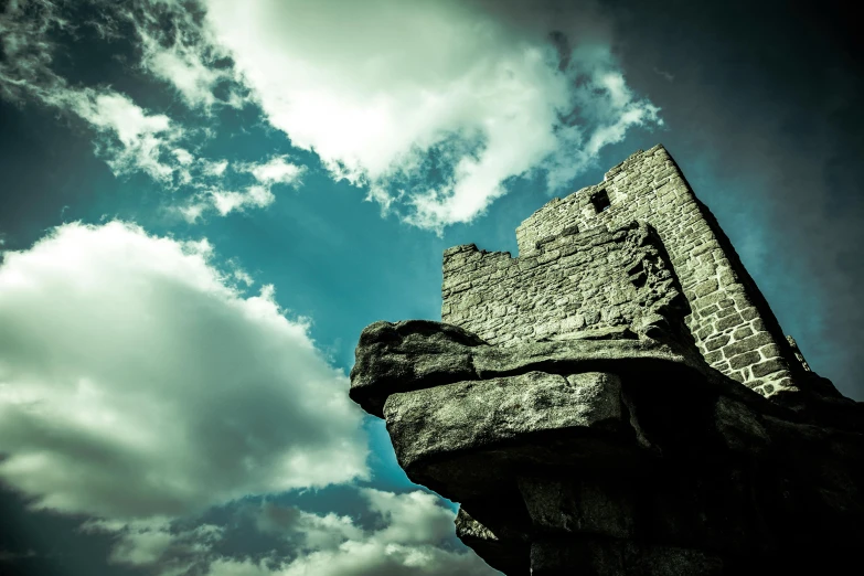 a large grey castle with sky in the background