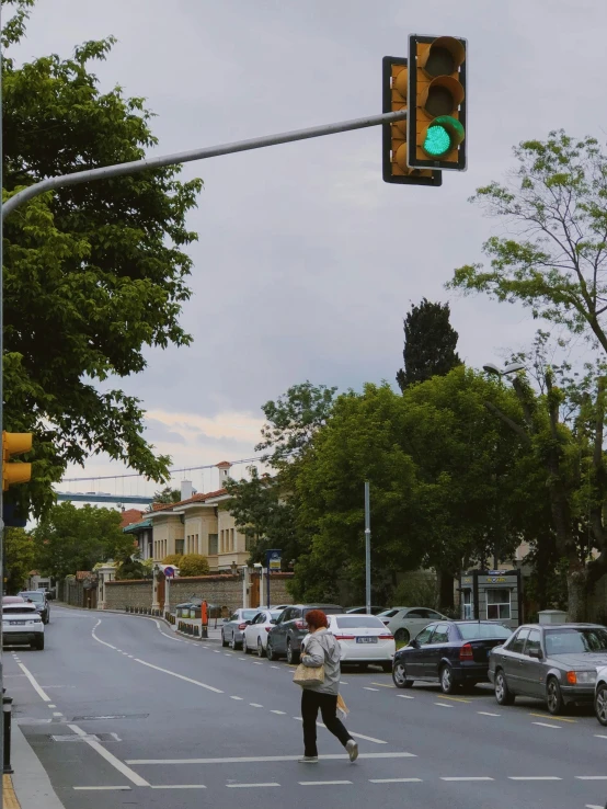 a person crossing at an intersection with a traffic light