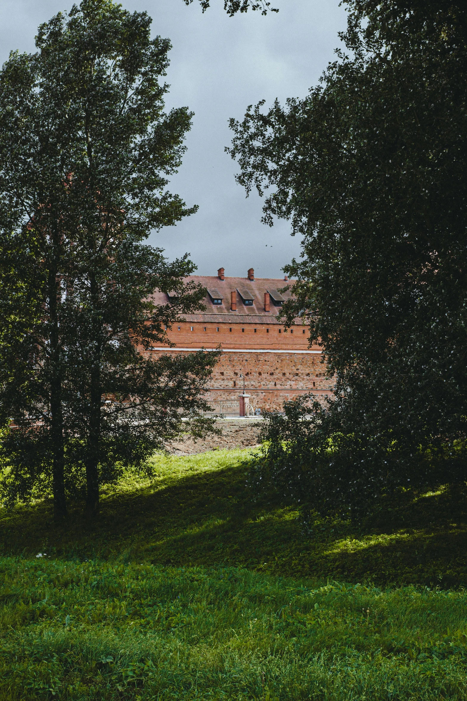 a large red brick building with windows in the back