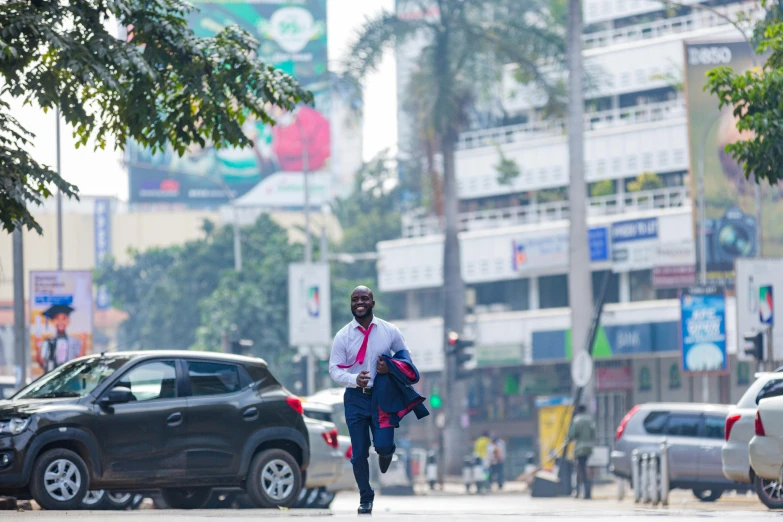 a man in business attire crossing an intersection