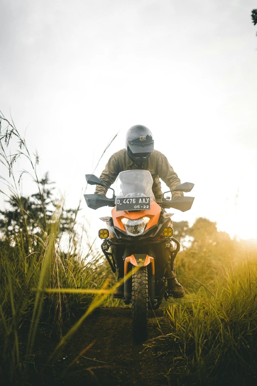 an atv rider dressed in full gear is going uphill