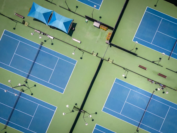 a green tennis court is shown from above