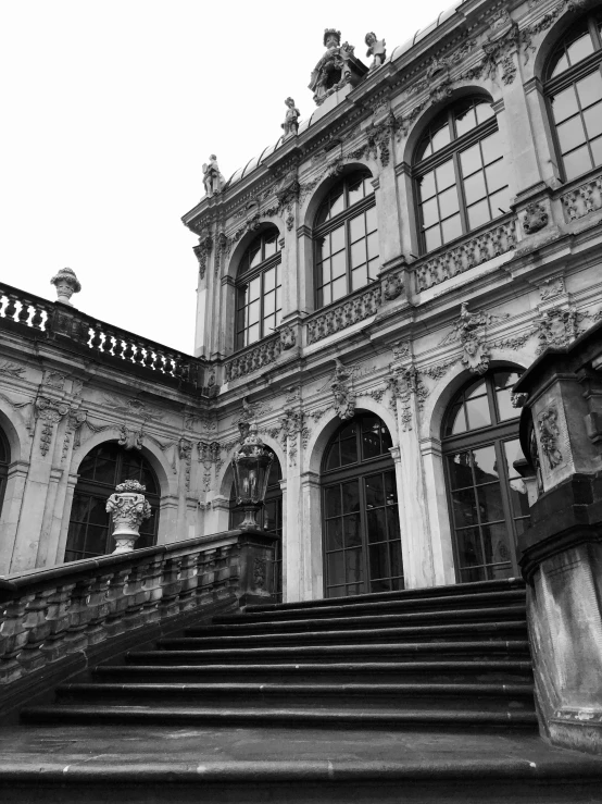 black and white pograph of a staircase outside a large building