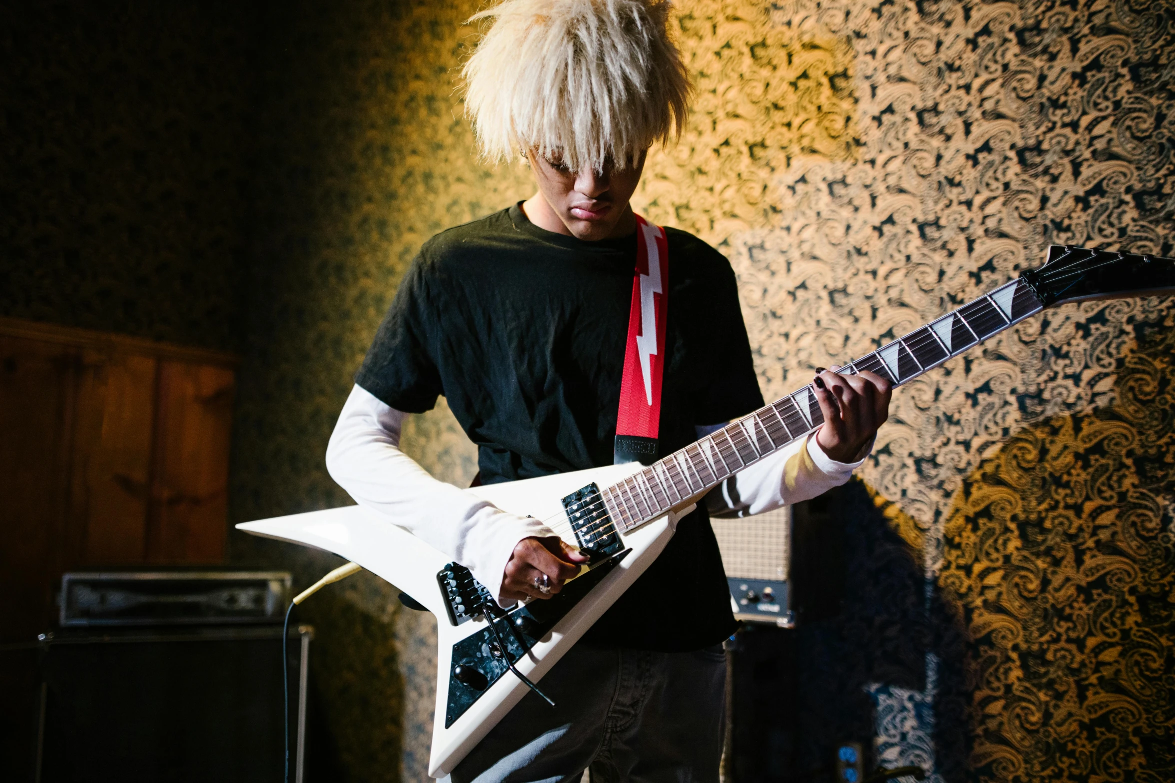 a man that is holding a guitar in his hands