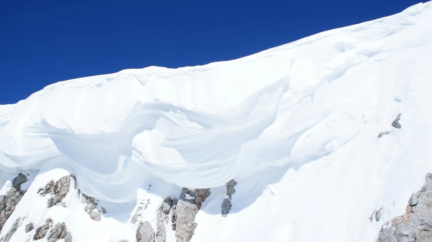 a person jumping over snow with his skiis