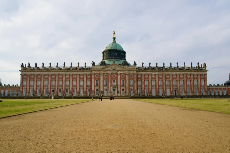 a large brick building with a dome shaped building on top