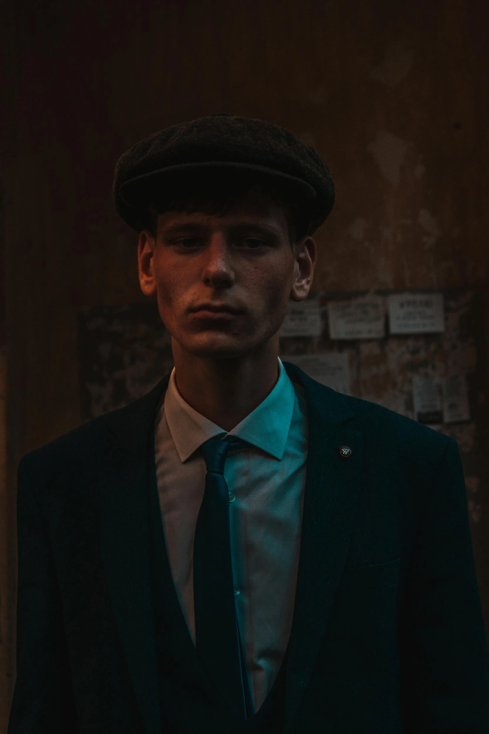 a man wearing a black hat and green tie