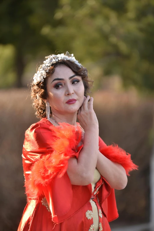 woman in red dress with feathers on her head