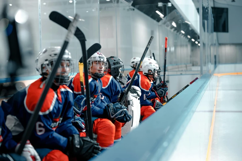 a group of ice hockey players sitting on the bench