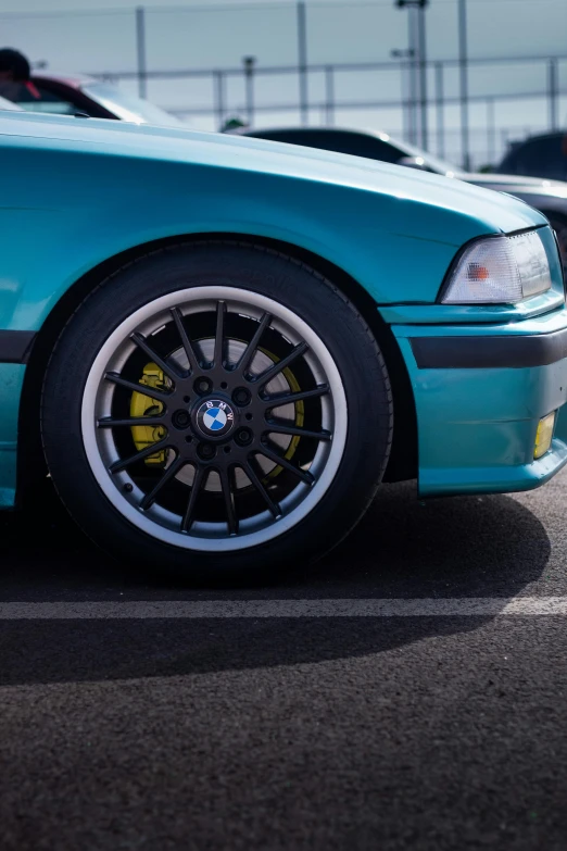 an e36 bmw cab parked in a parking lot