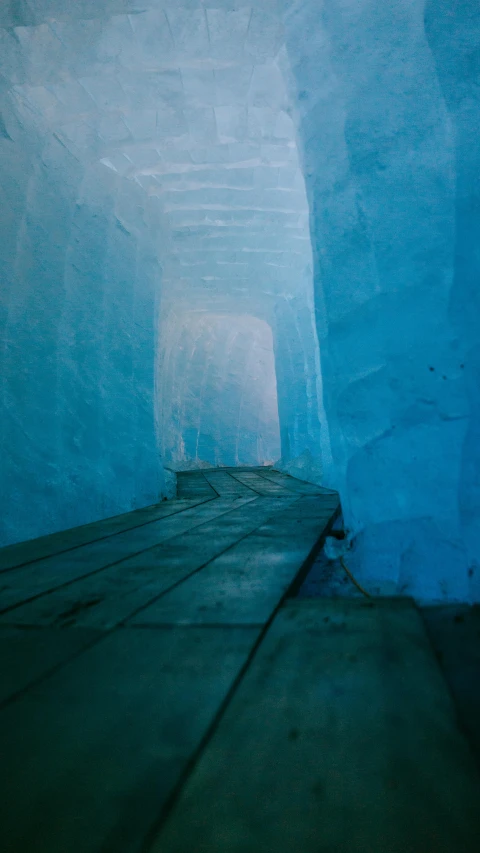 two blue colored ice caves with dark shadows