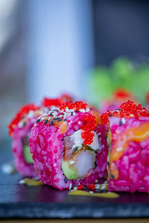 sushi rolls sit on a  board with some vegetables