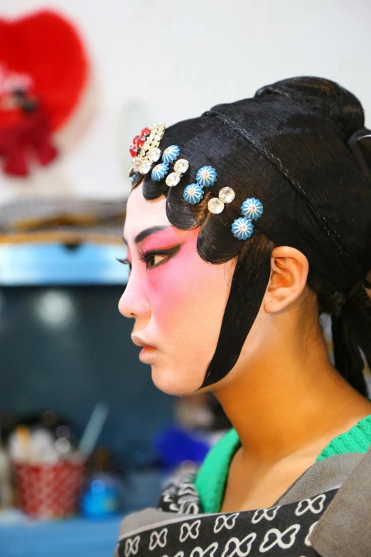 woman in black traditional dress with blue and pink makeup