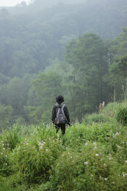 the man is walking in the woods alone