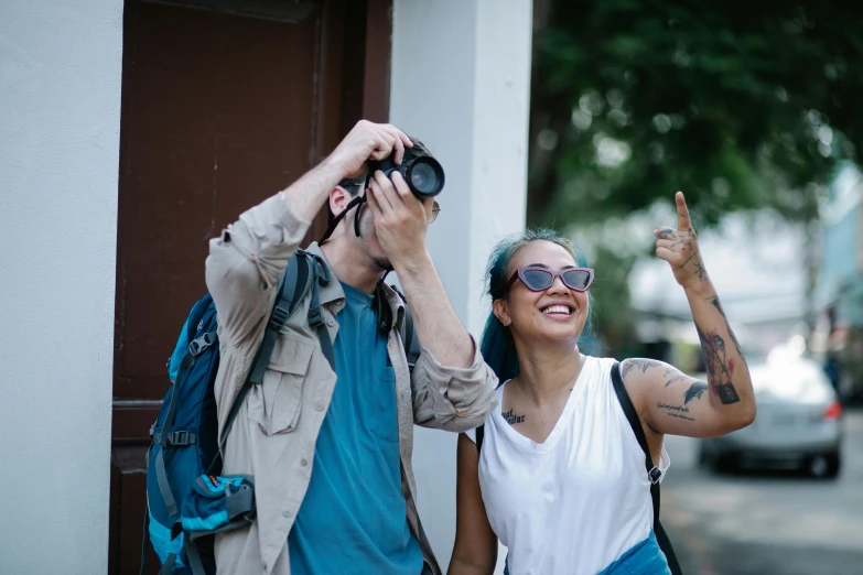 a man and woman standing next to each other on a street