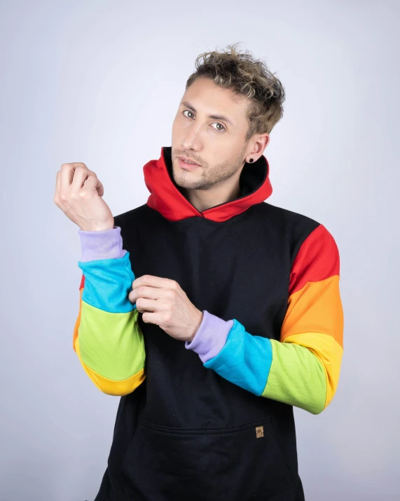 man in colored hoodie, looking up to the side