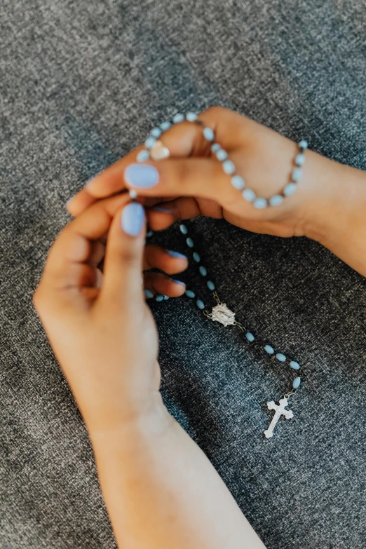 the woman is praying on her rosary