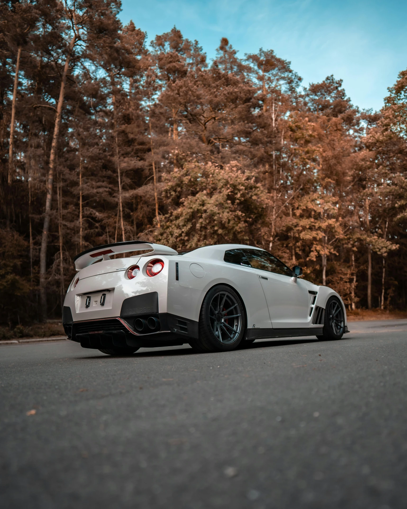 a sports car is driving through the woods