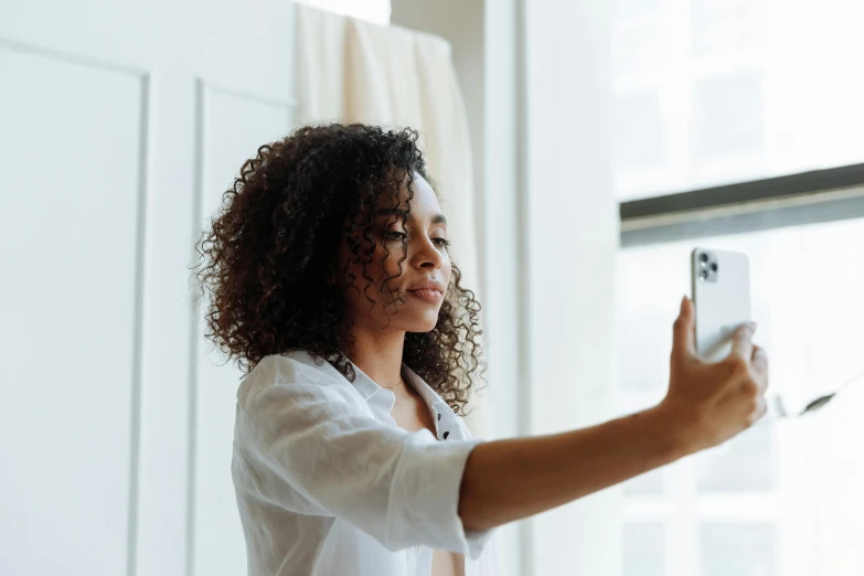 a woman is pographed with her phone and taking pictures