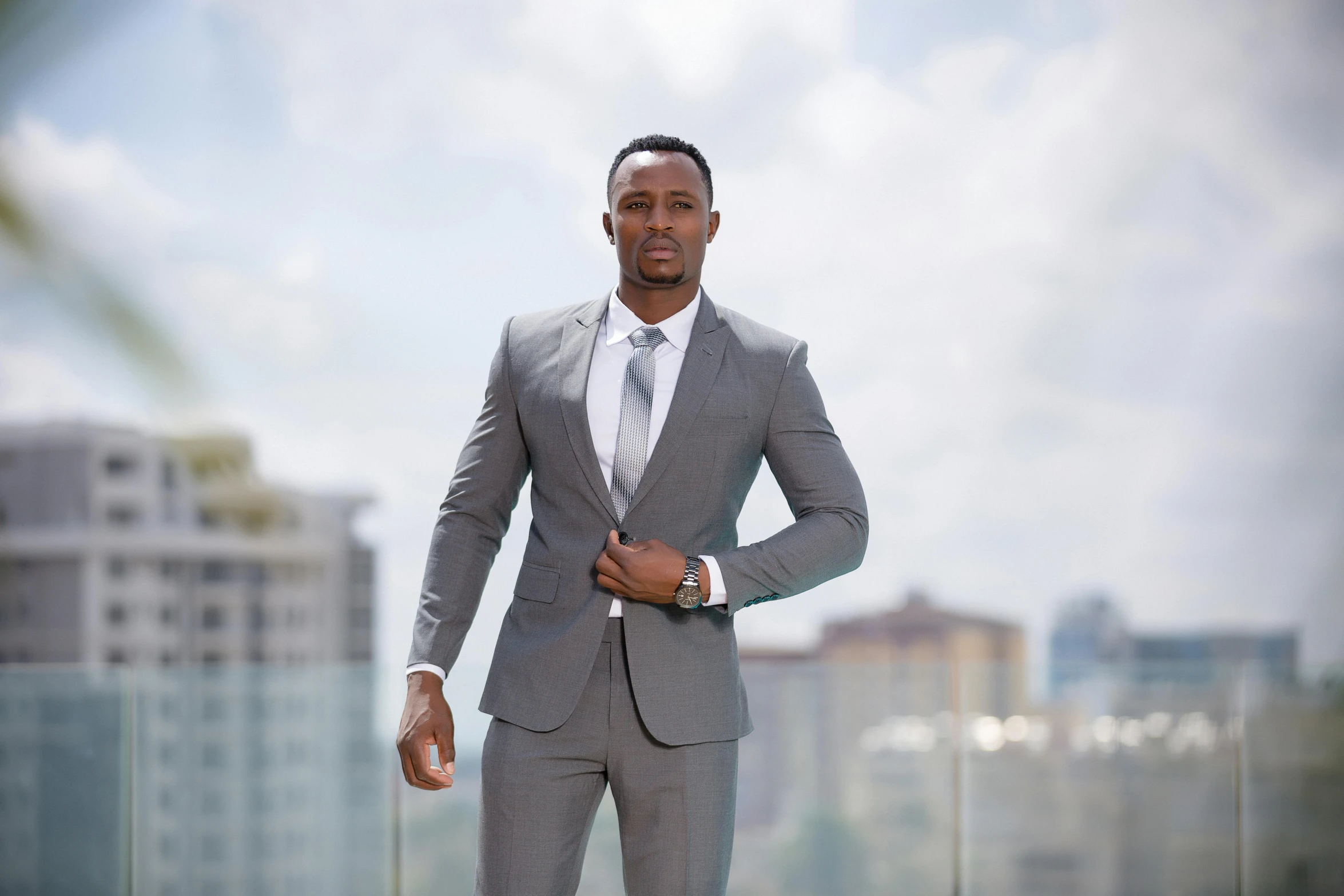 a man in a suit poses for a picture