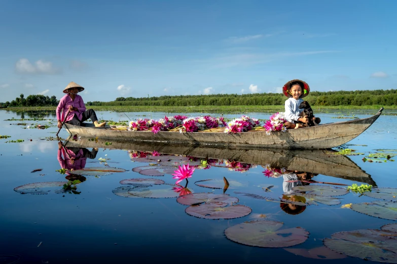 two people in the middle of a boat on water