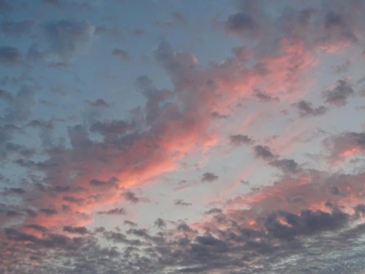 the view of some clouds with different colors at sunset