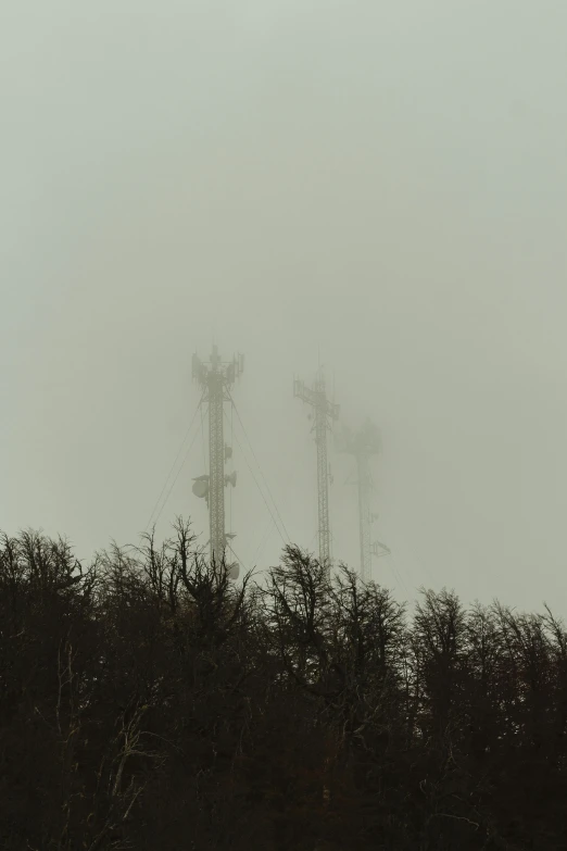 multiple electric towers with the sky in the background