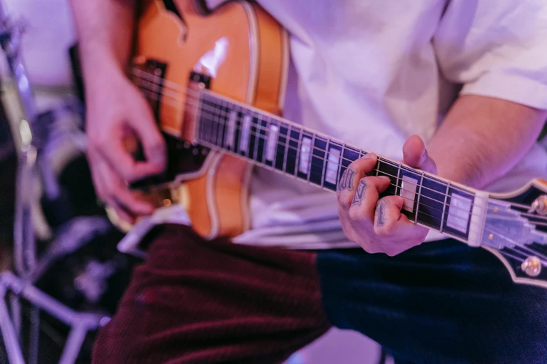 someone plays a guitar in a music studio