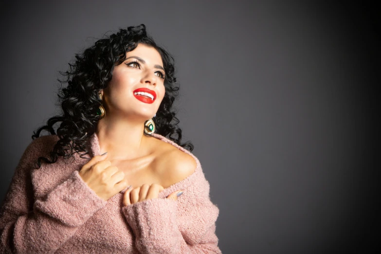 a woman in pink sweater posing for a picture