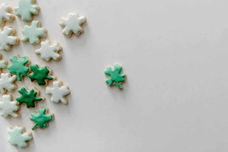 a plate with cookies decorated with white and green frosting