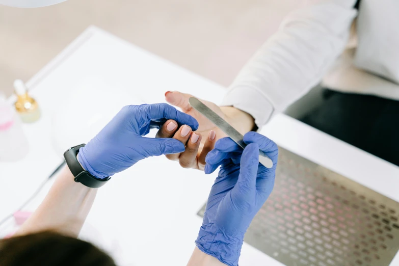 two people are injecting soing into the hand of another person