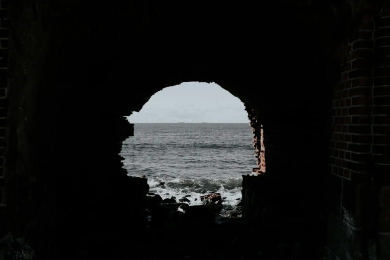 an entrance to the ocean with waves coming in