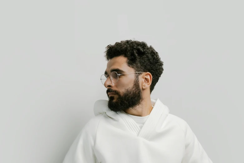 a man with a beard and glasses posing for the camera