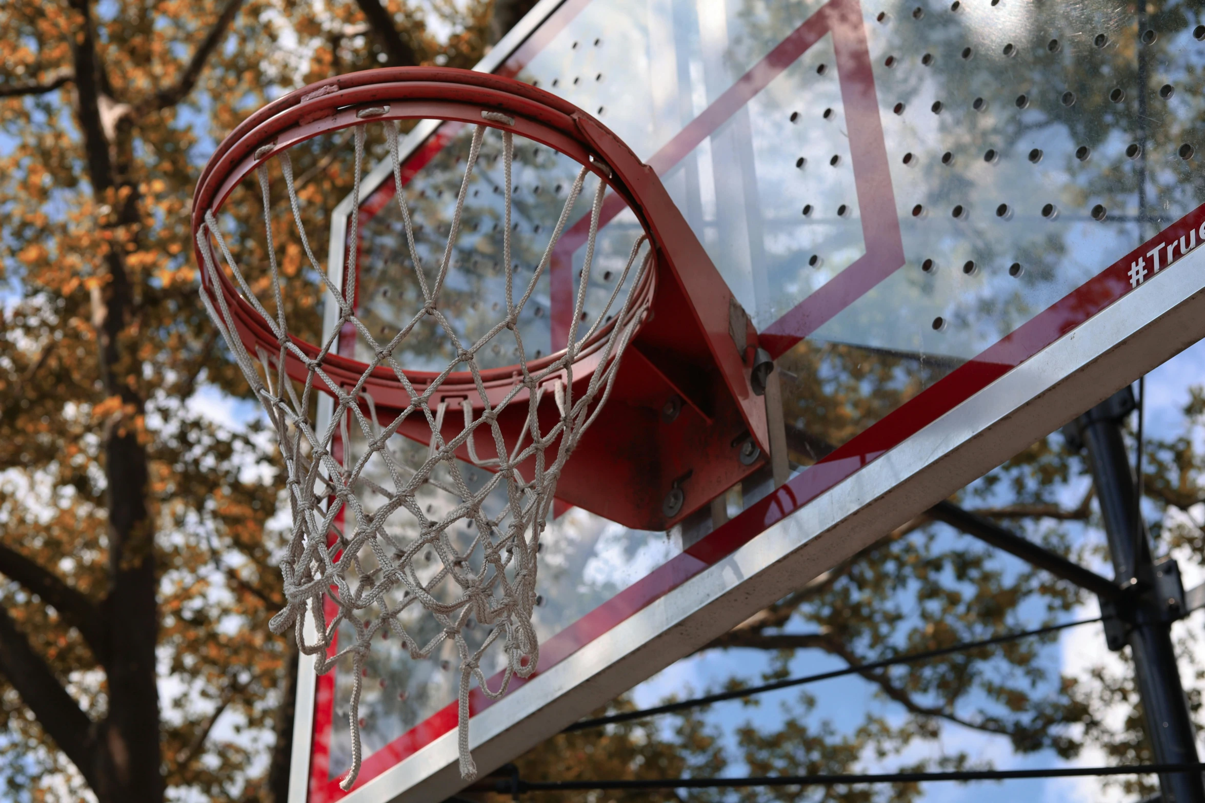 a basketball going through the net on a cloudy day