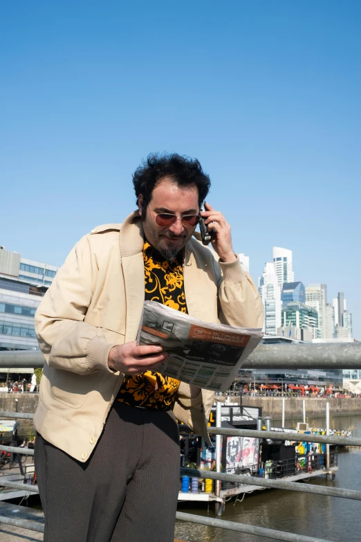 a man in glasses talking on a cell phone