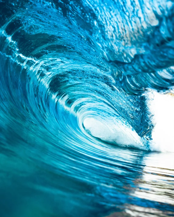 blue waves are crashing in the ocean on a sunny day