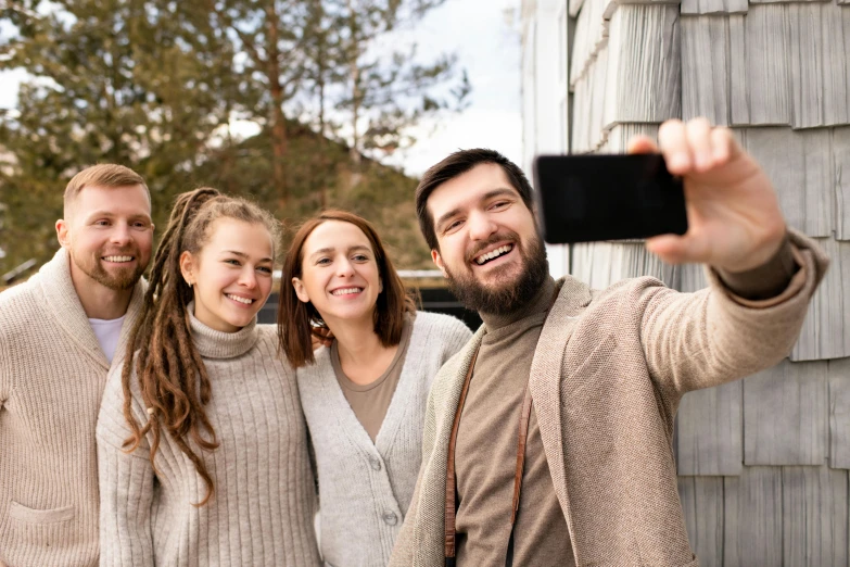 three people taking a po while another couple stands beside of them