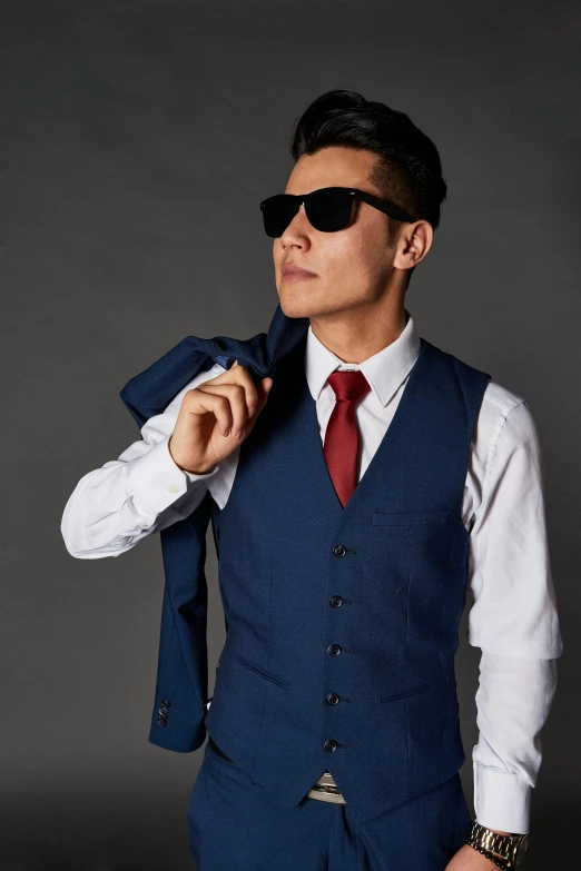 young man in sun glasses fixing his red tie